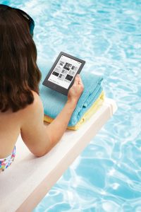 Woman with tablet pc on pool raft